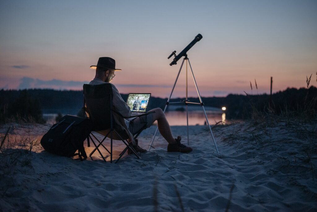 a male freelancer working during his vacation telescope